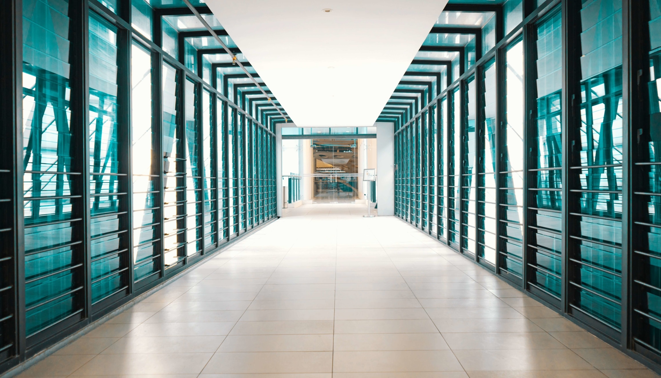 A hallway with glass windows at a tech company.